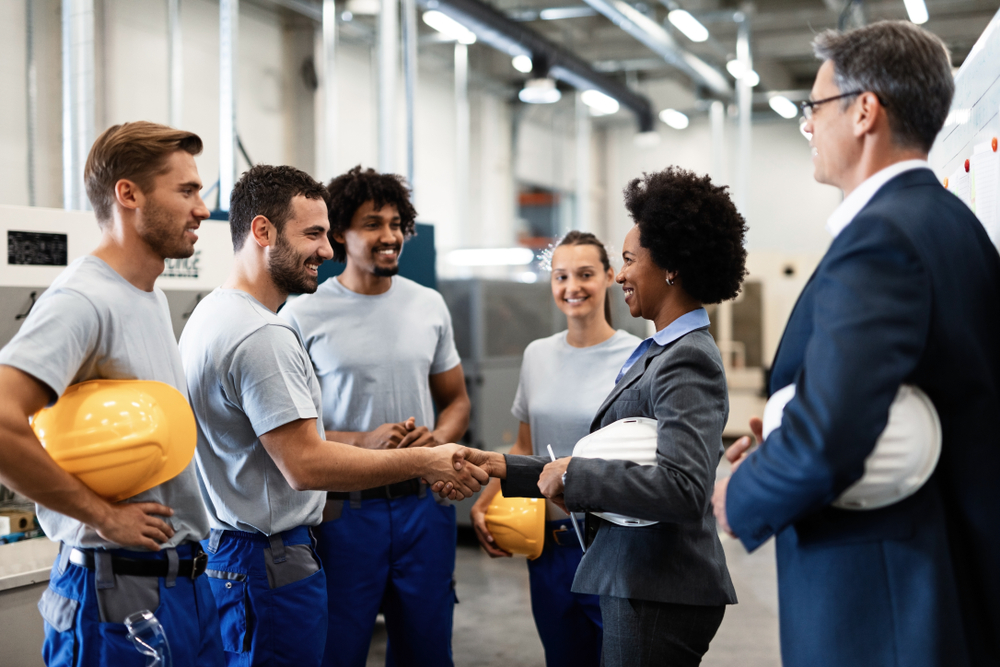 Image of people shaking hands in a warehouse